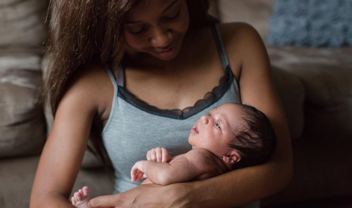 Black woman holding baby