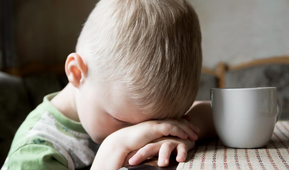 Boy with head on table