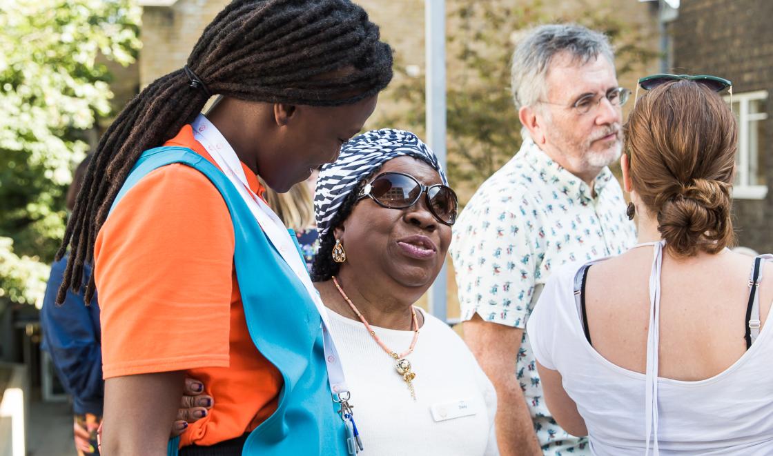 Social care staff with service users at garden party