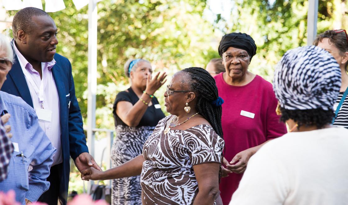 Garden party black woman holding hands with black man