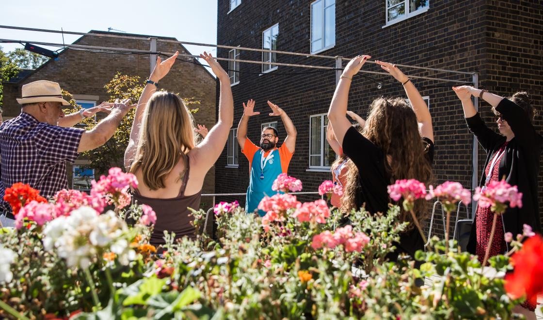 Group of people stretching outdoors in mindfulness session