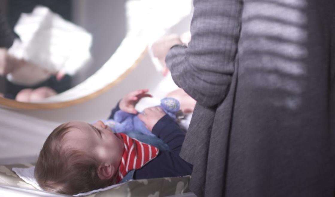 Mother changing baby