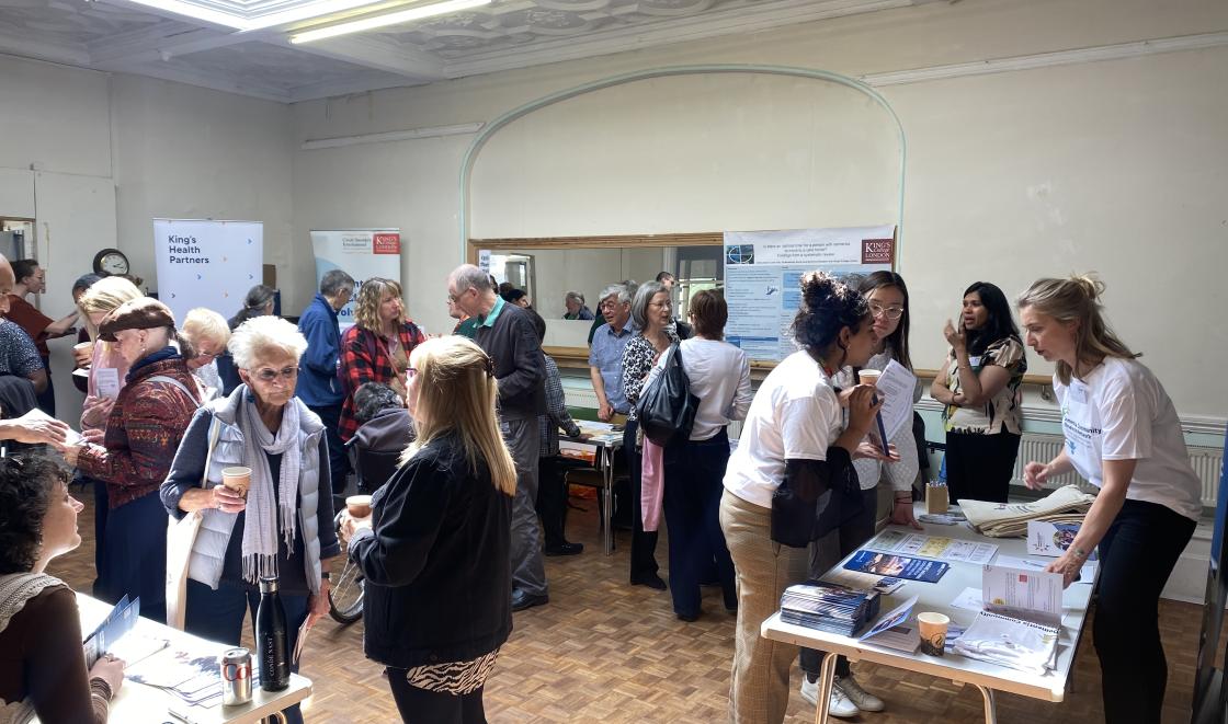 Individuals networking at stalls at the DCRN event