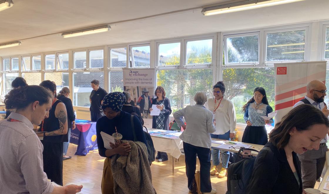 Individuals networking at stalls at the DCRN event