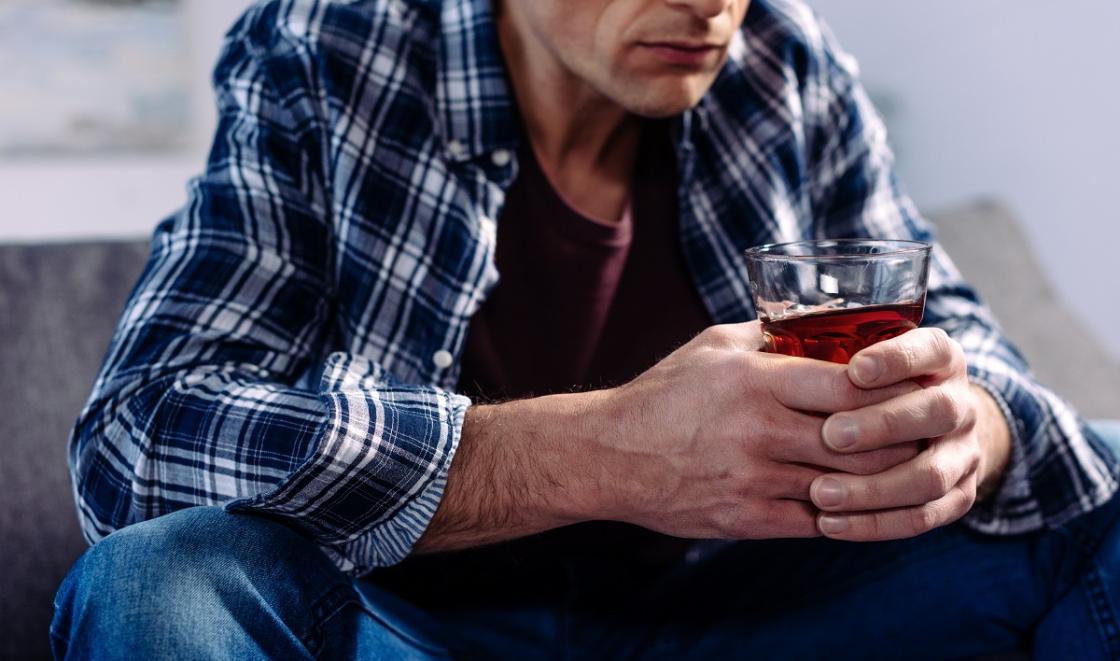 Man holding pint of beer
